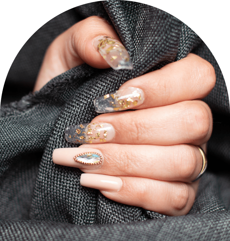 Hand with decorative, glittery acrylic nails.